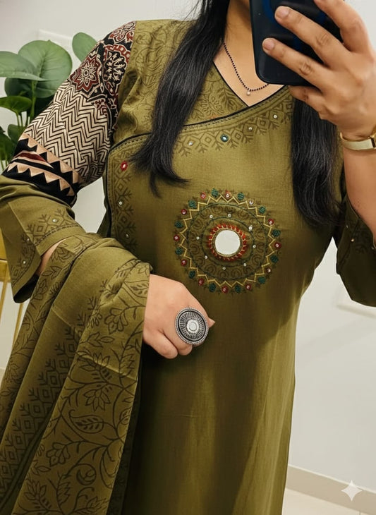 green kurti pant with a floral print and mirror work embroidery. 