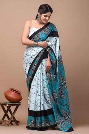 woman wearing a light teal and white saree.